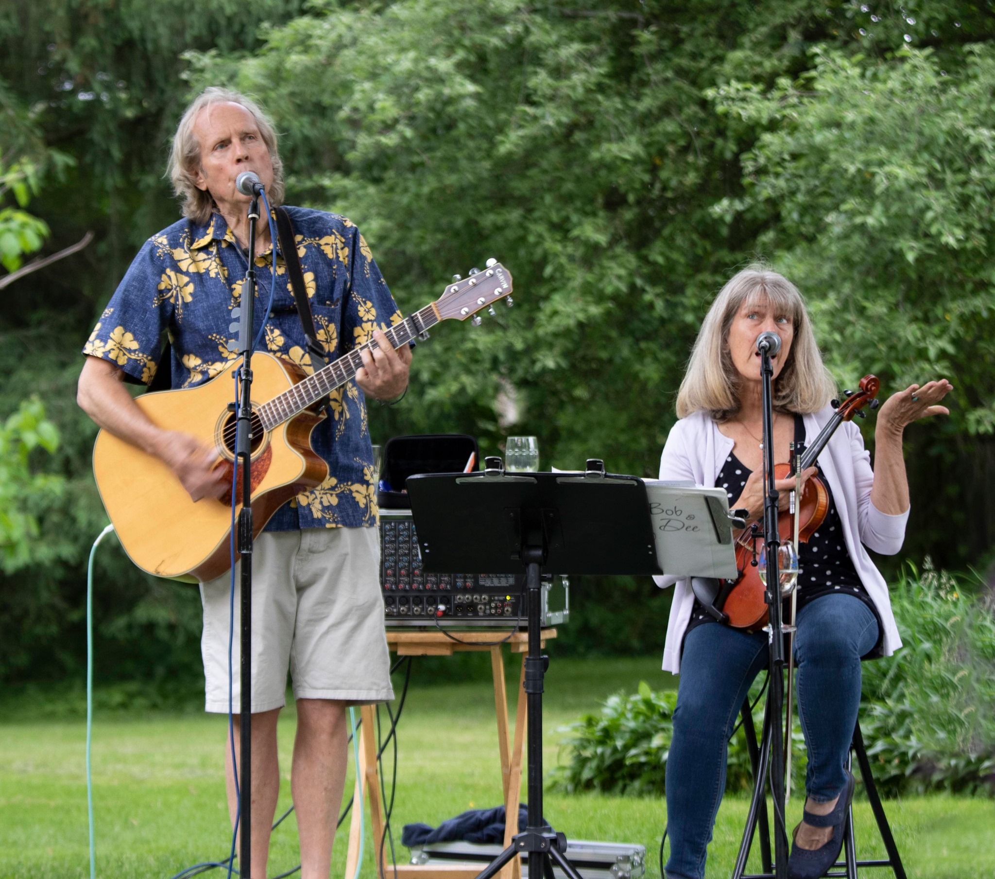 Bob and Dee playing live music outside.