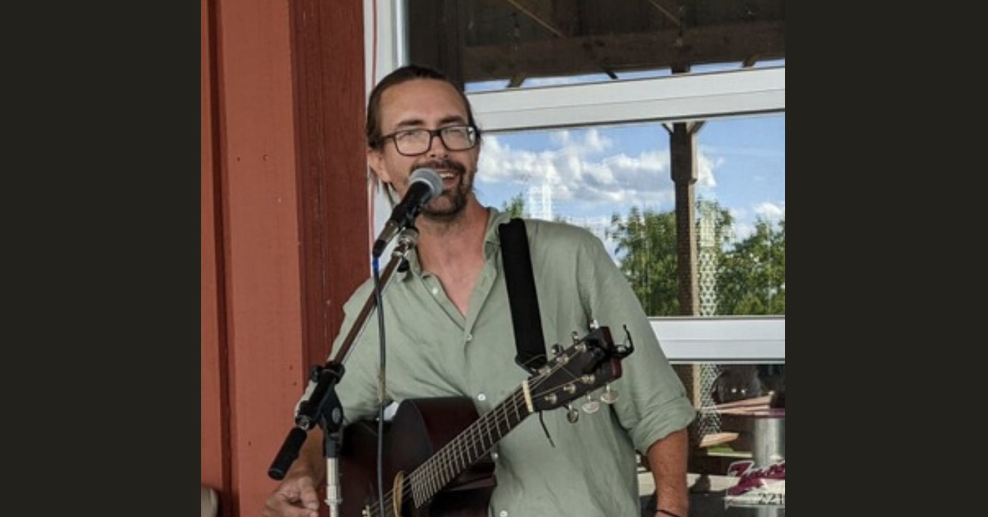 JoeLule Joe Lule with a guitar and microphone.