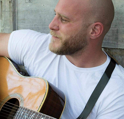 EvanDillon_400pxW Evan Dillon playing guitar.