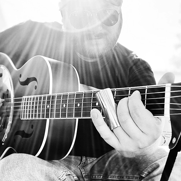 TCLarkHiBeamsWebCalnedar600px Trevor Clark of Hi-Beams playing guitar.