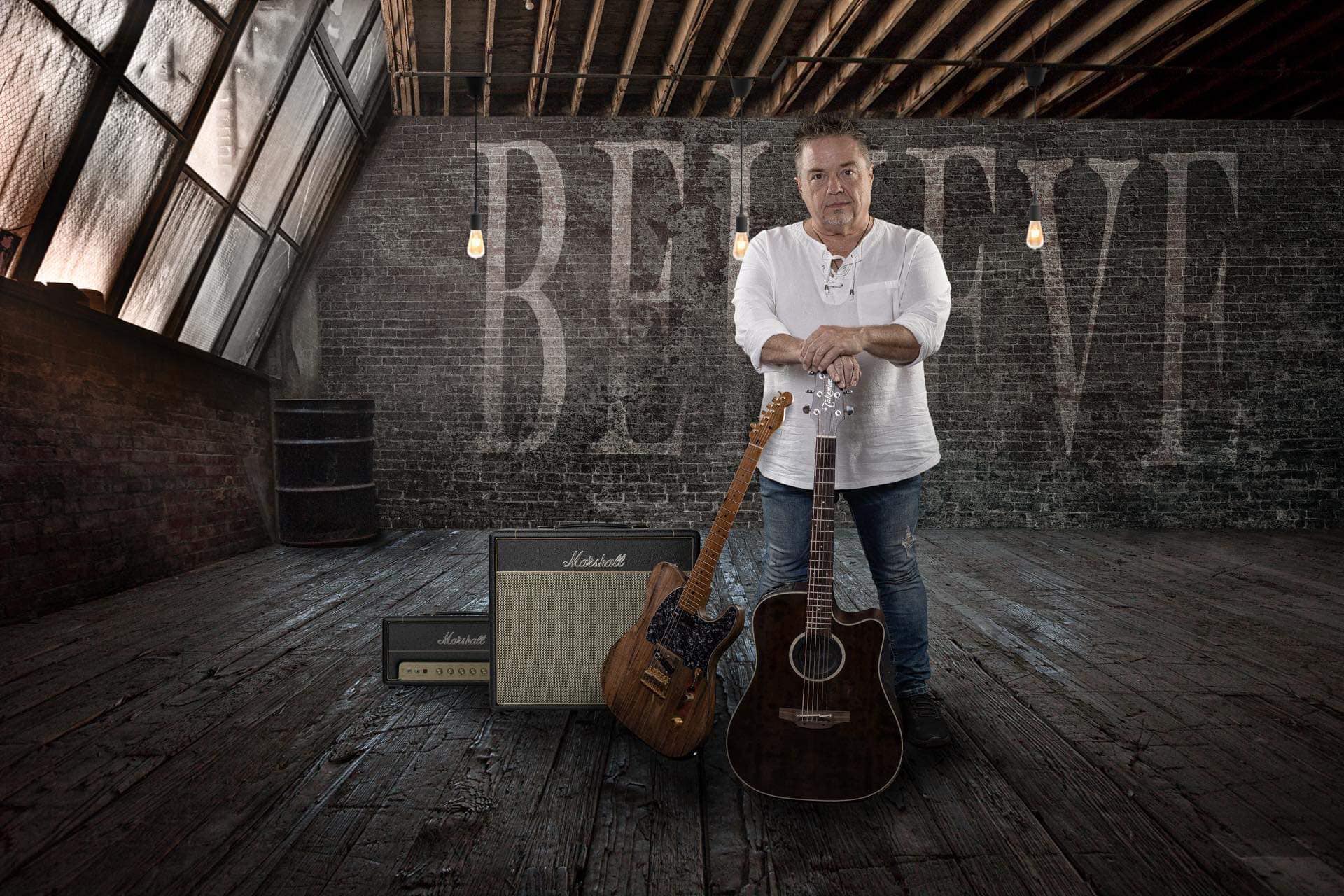 BrianHughes Brian Hughes posing with guitars.