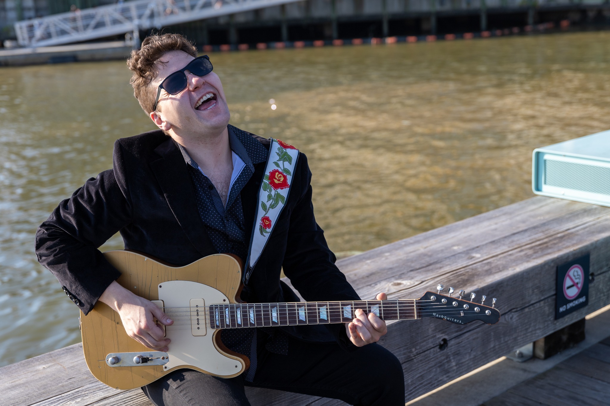 Gabe Stillman playing live music by the water.
