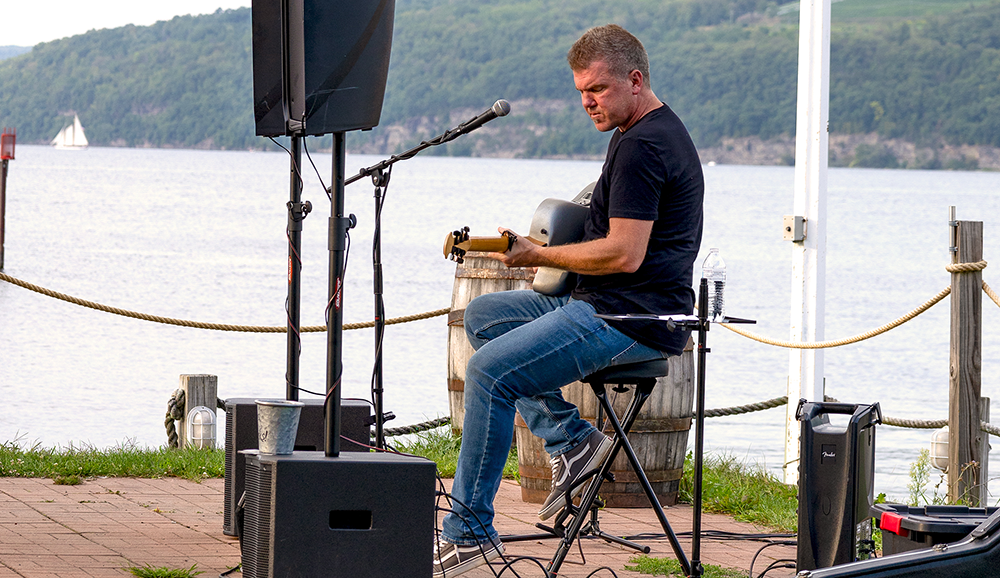 TremayneHarerAcoustic_1000pxW Tremayne Harer playing live music next to lake.