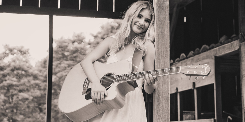 MadelynRose Madelyn Rose playing live music with her guitar.